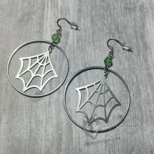 Handmade earrings with laser cut stainless steel spider web charms inside large stainless steel rings with light green Austrian crystal beads, on stainless steel earring hooks