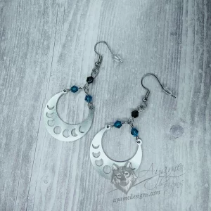 Handmade earrings with laser cut stainless steel moon phase charms with teal and black Austrian crystal beads, on stainless steel earring hooks