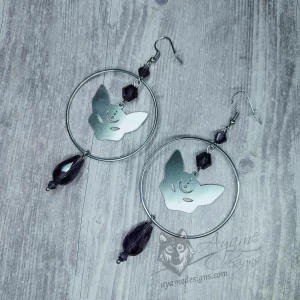 Handmade earrings with laser cut stainless steel cat pendants inside large rings, with purple Austrian crystal beads, on stainless steel earring hooks