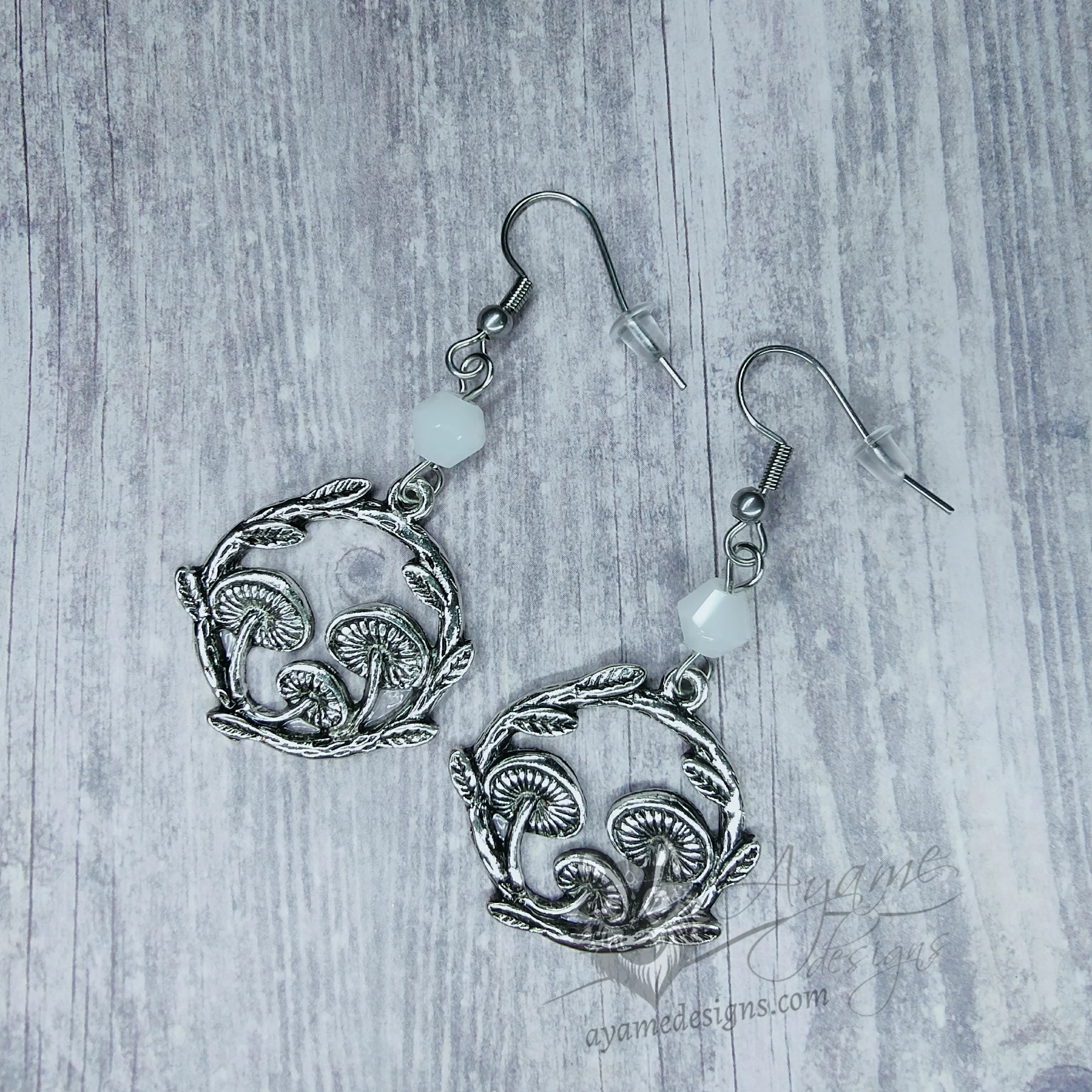 Handmade cottagecore earrings with mushroom charms, white Austrian crystal beads and stainless steel earring hooks