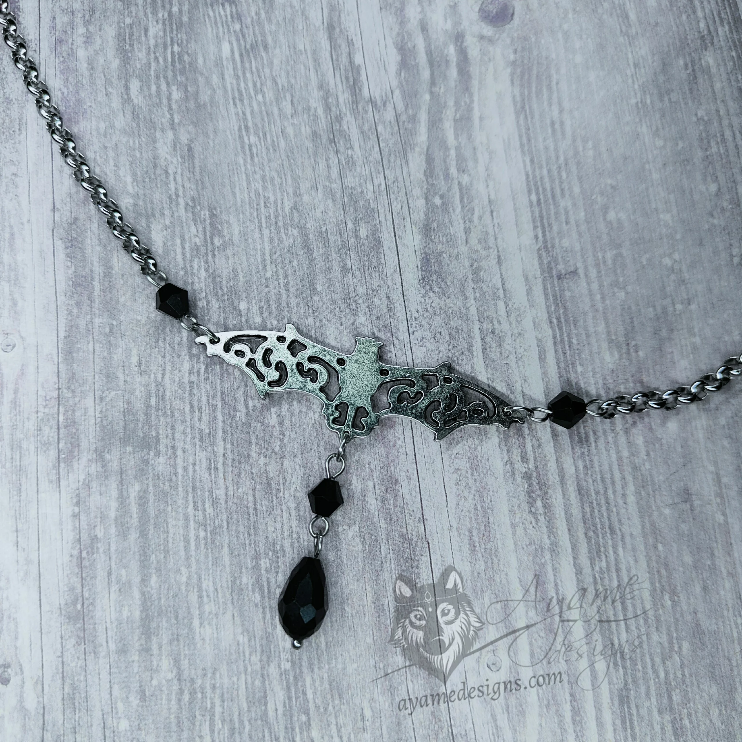Handmade fantasy head chain with a filigree bat, black Austrian crystal beads and stainless steel chain