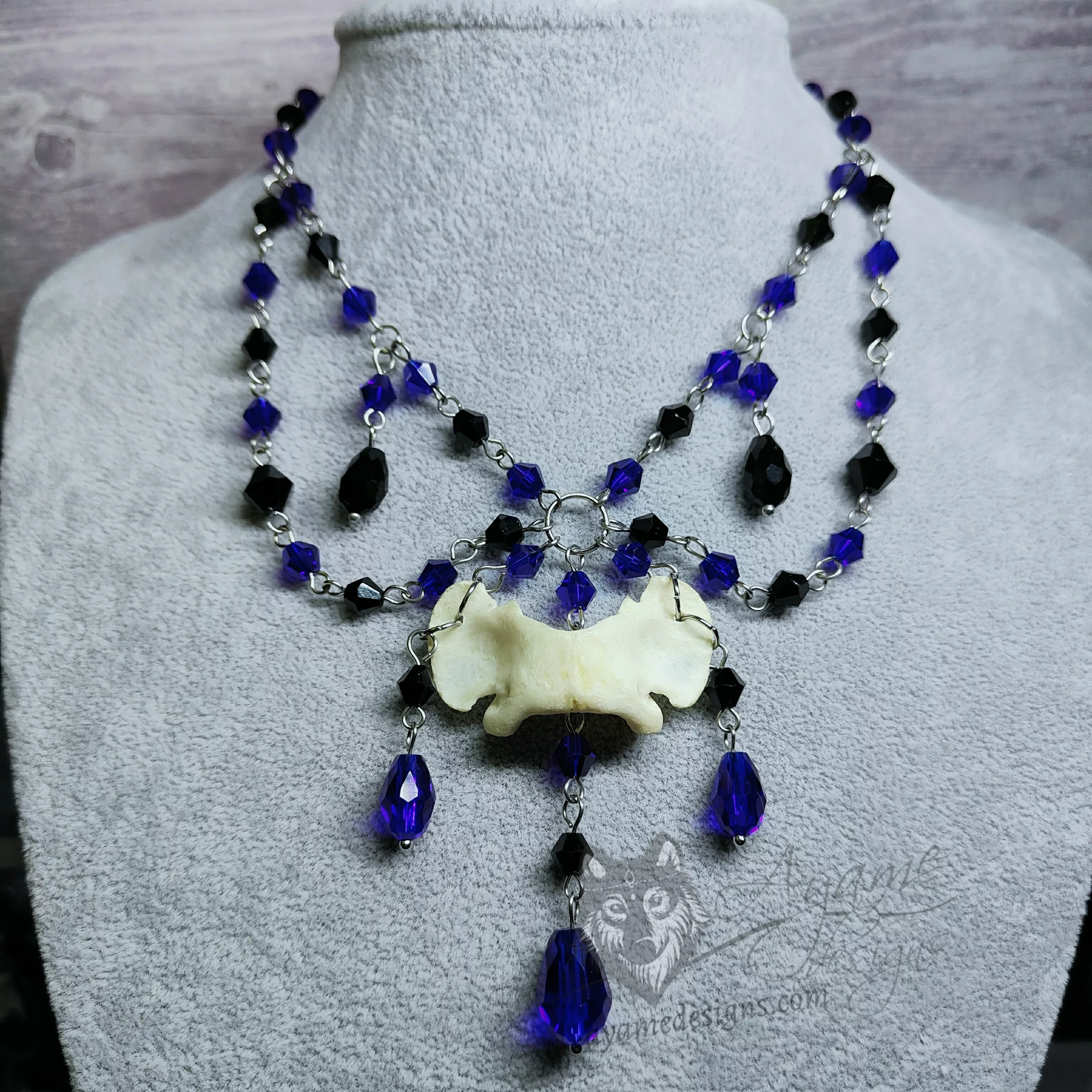Handmade choker necklace with ethically sourced dog atlas bone, black and blue crystal beads and stainless steel