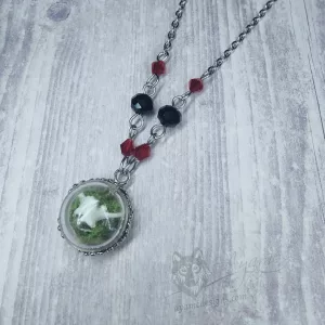 Glass dome necklace with ethically sourced snake vertebrae and moss, red and black Austrian crystal beads and stainless steel chain