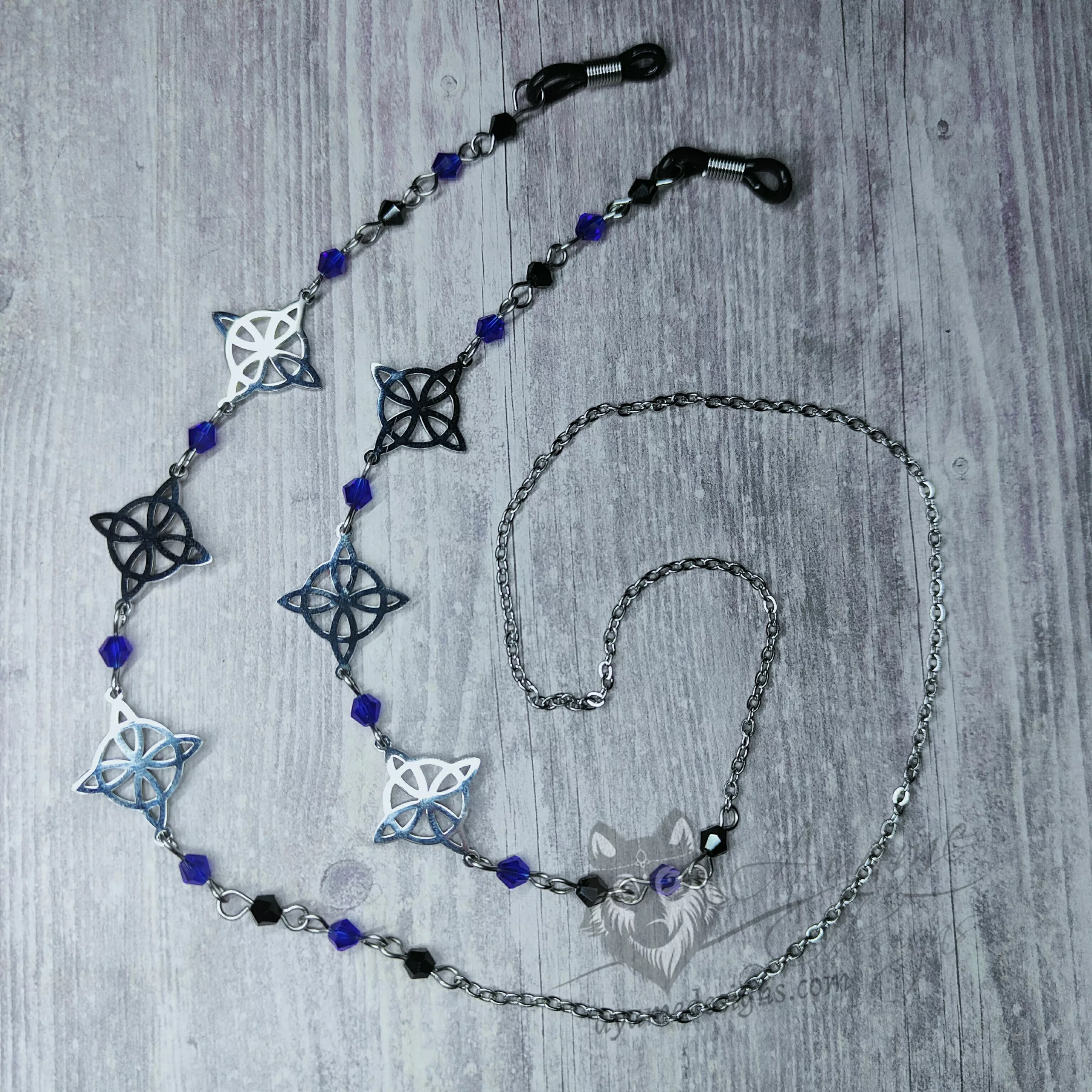 A handmade glasses chain made with laser cut stainless steel witch's knot pendants (three on each side), Austrian crystal beads and stainless steel chain