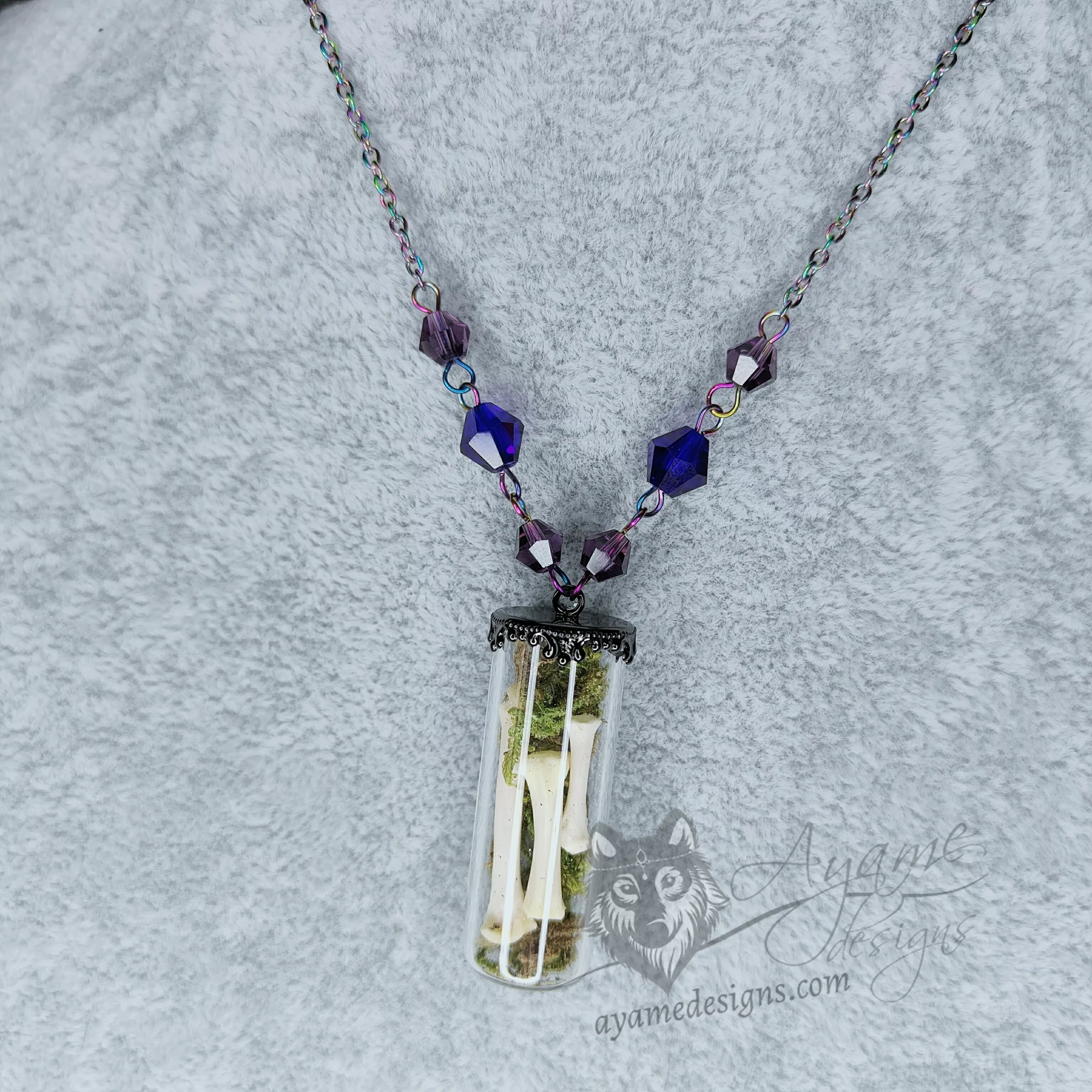 Glass vial necklace with ethically sourced dog bones and moss, purple and blue Austrian crystal beads and rainbow stainless steel chain