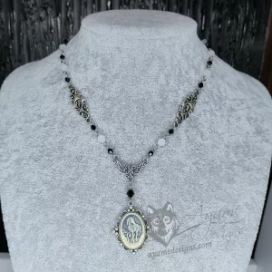Handmade fantasy necklace with a unicorn cameo in a filigree frame, and black and white Austrian crystal beads