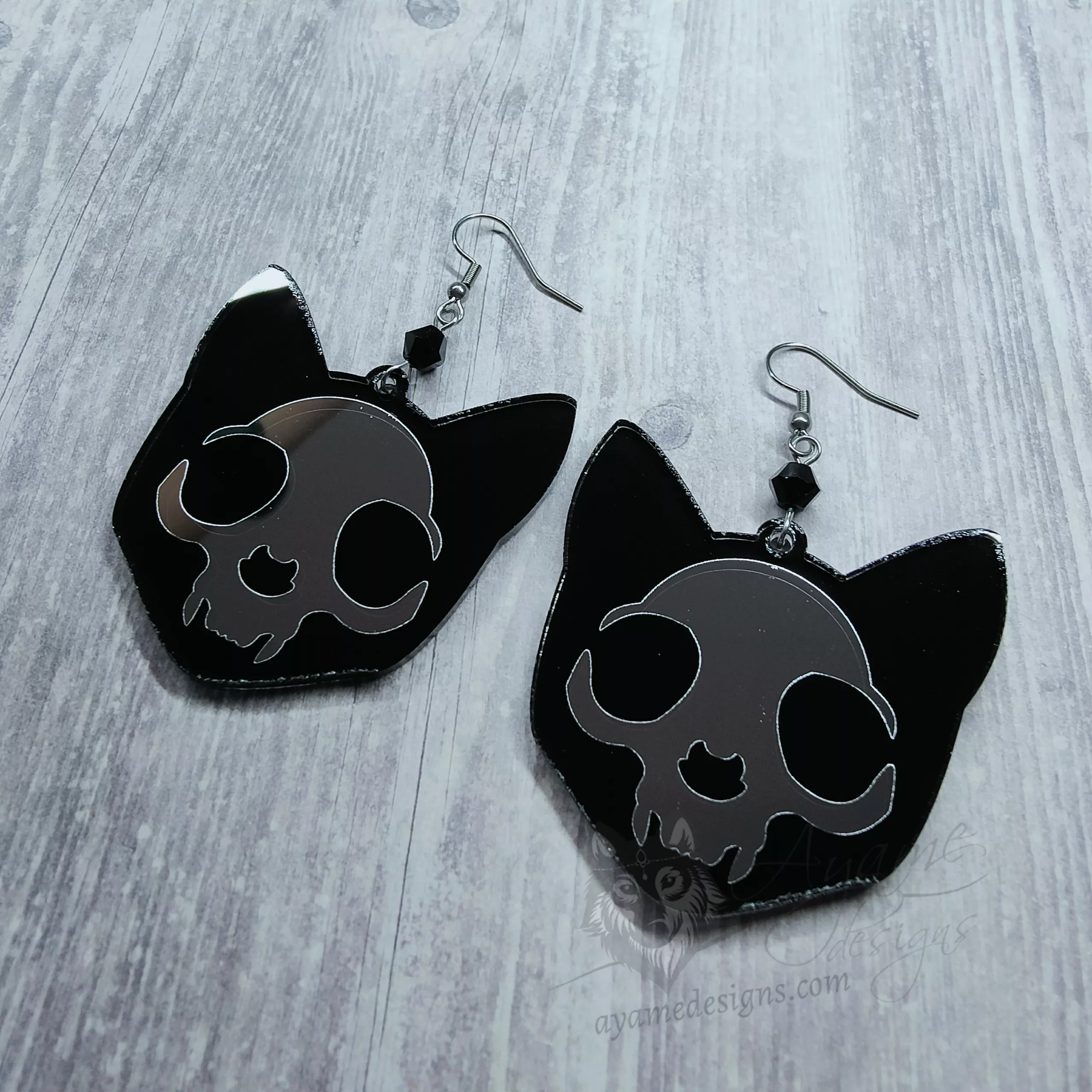 Handmade gothic earrings with laser cut mirror and resin cat skull pendants and black Austrian crystal beads on stainless steel earring hooks