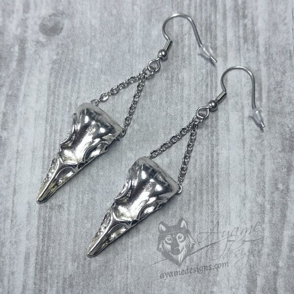 Earrings with bird skull pendants hanging on stainless steel chain, on stainless steel earring hooks