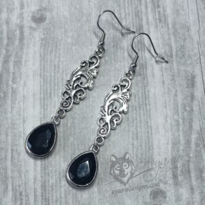 Elegant gothic earrings with filigree connectors and green teardrop charms, on stainless steel earring hooks